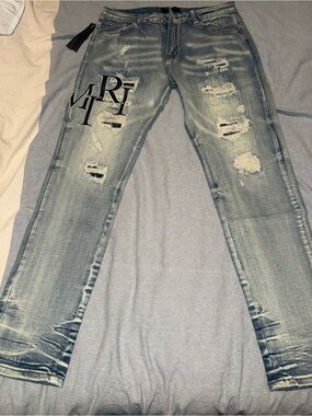 AMIRI Light Blue Distressed Slim Straight Jeans with Black Logo Appliqué